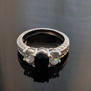 Silver ring with black oval cut gemstone
